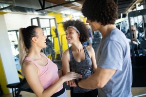 Happy gorup of healthy people training in gym
