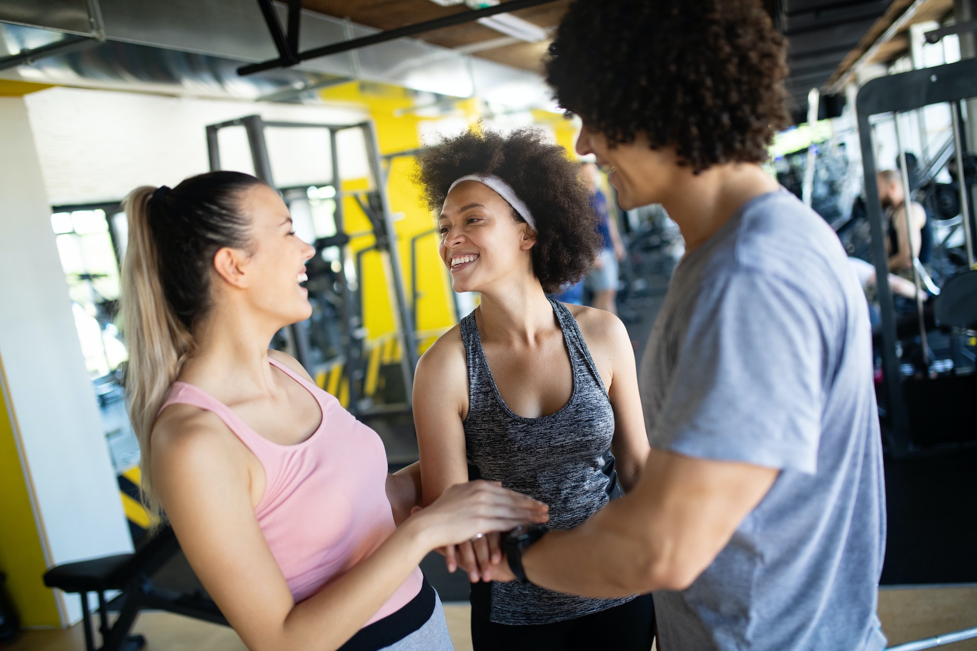 Happy gorup of healthy people training in gym